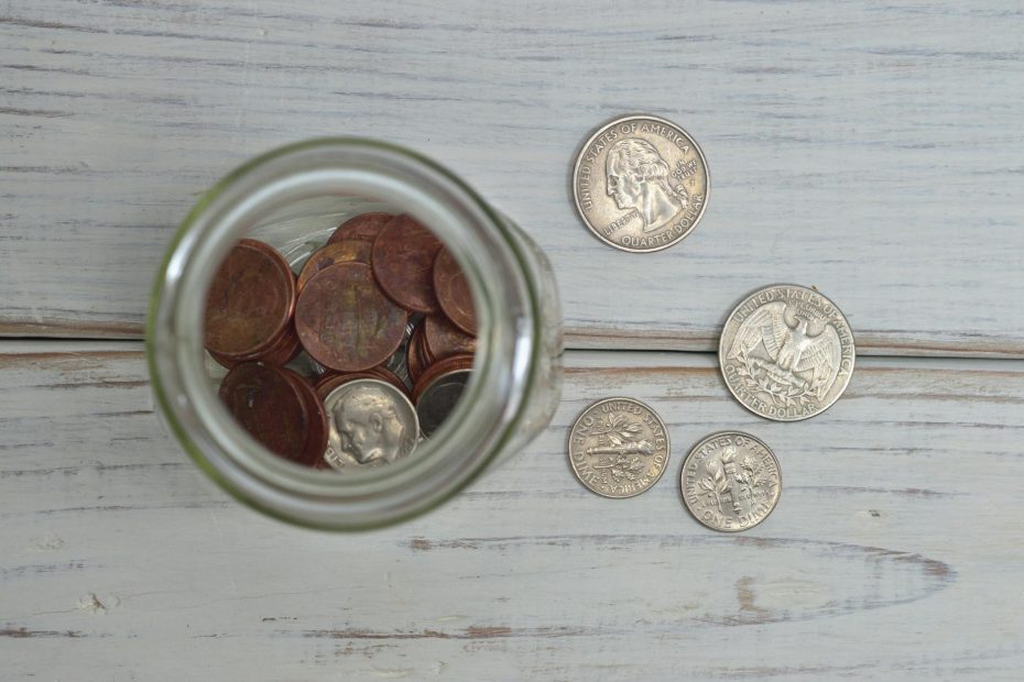 Illustration of a piggy bank with coins and a dollar sign, symbolizing frugal living.