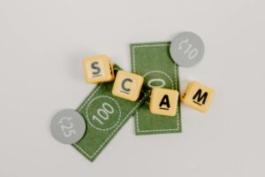 Illustration of shield protecting money from scammer hands.
