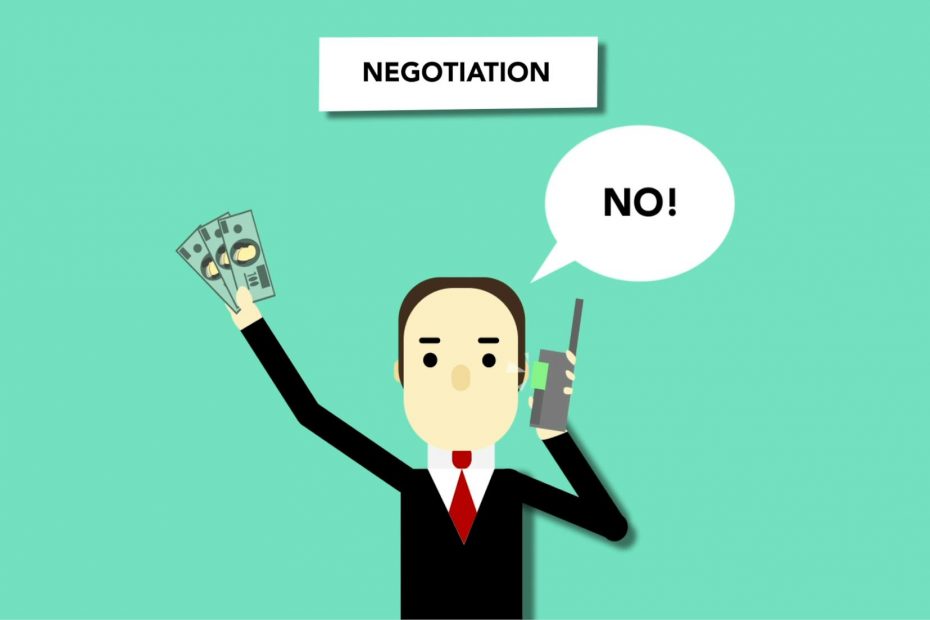 Man and woman shaking hands at a desk; salary negotiation