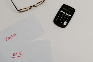 Illustration of a person triumphantly breaking chains labeled "debt."