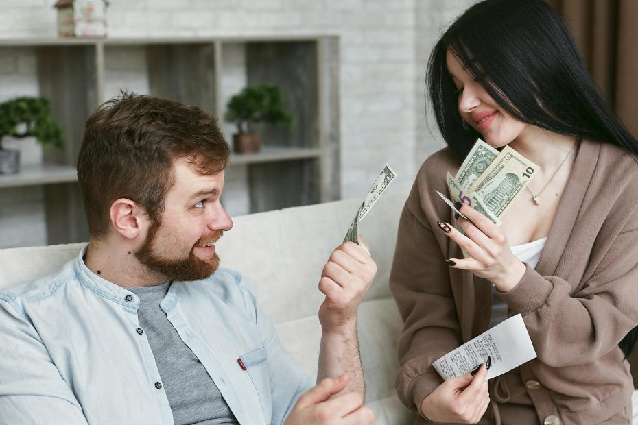 Couple sits at a table discussing finances and future planning.